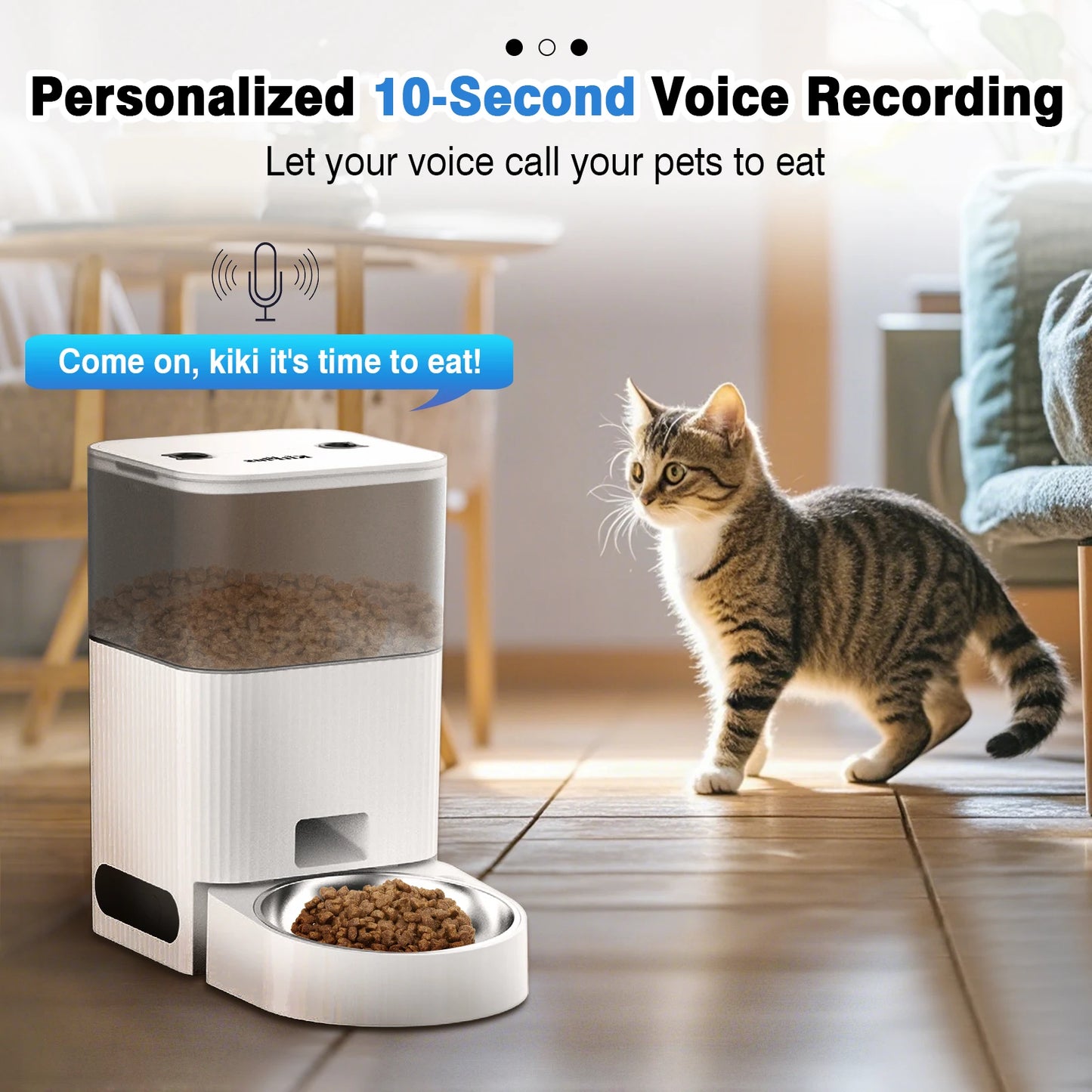 Cat standing next to a pet feeder with a voice recording feature, in a home setting.