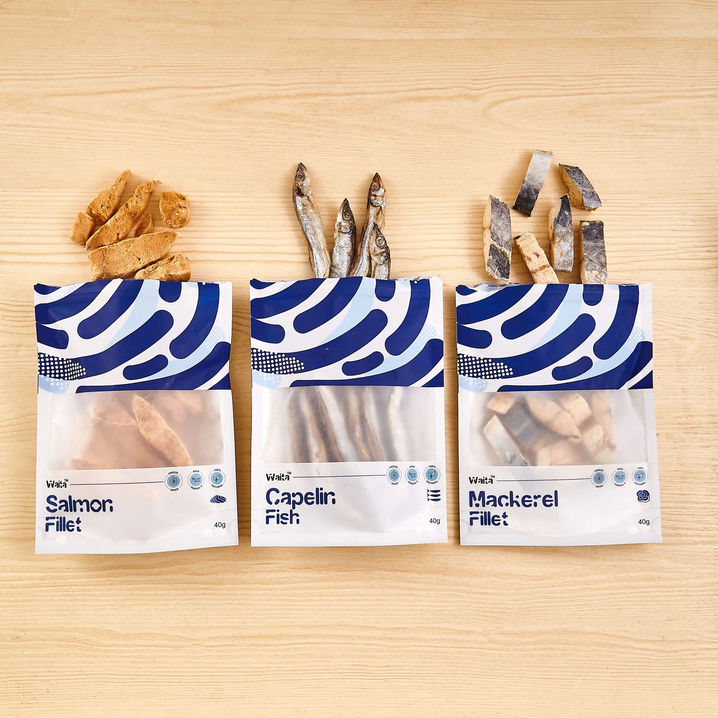 Three packages of fish fillets with visible branding on a wooden surface