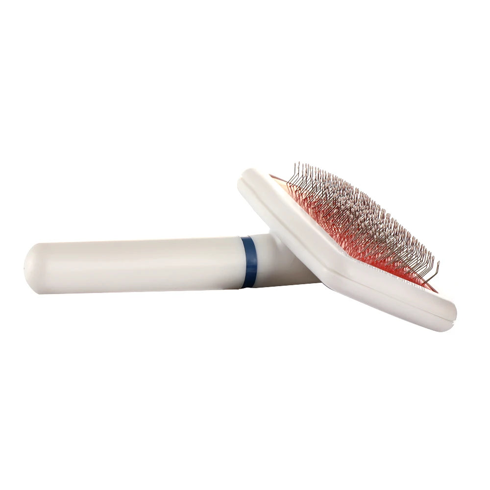 Pet grooming brush with red bristle head on a white background