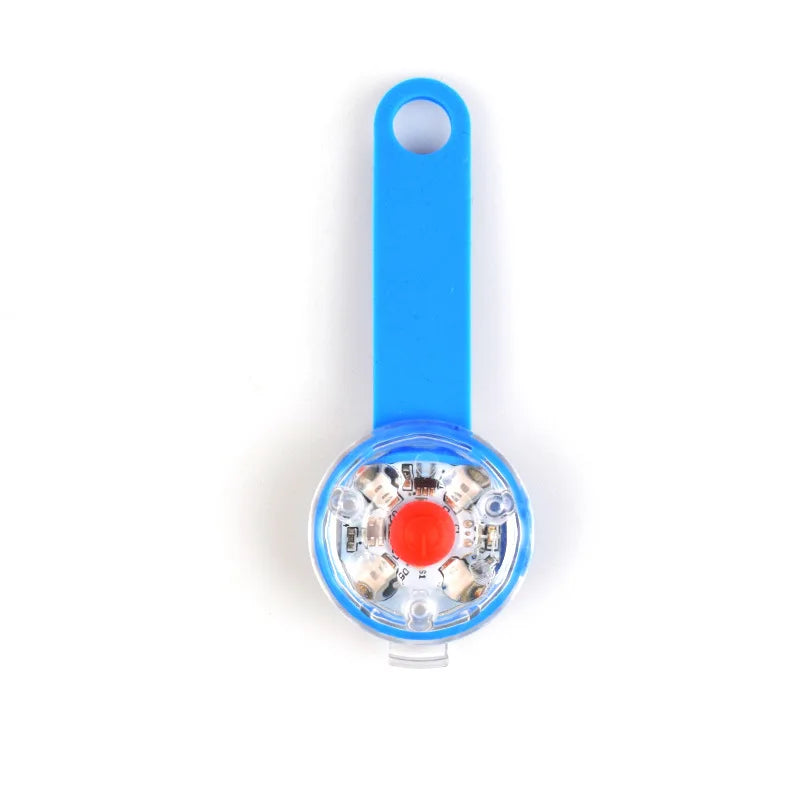 Blue flashlight with a red button on a white background
