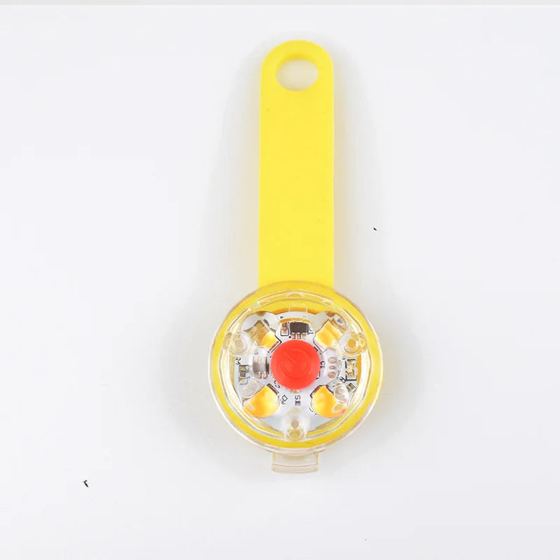 Yellow handheld device with a red button on a white background