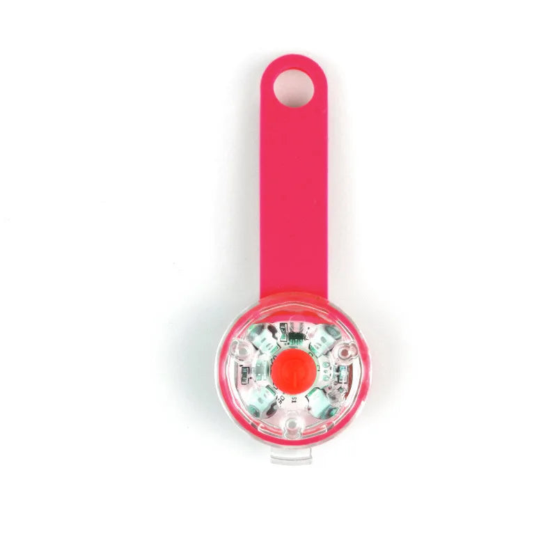 Pink bicycle light with a clear cover on a white background