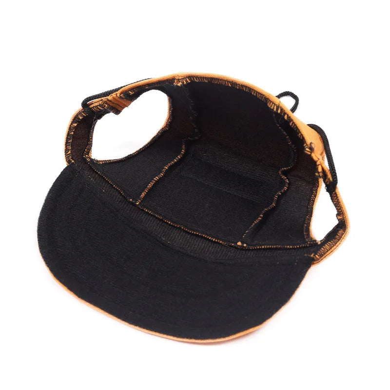 Black visor cap with brown rim on a white background