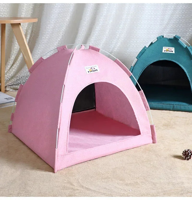 Pink pet tent on a wooden floor with a white curtain background