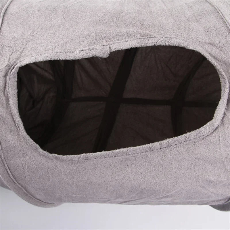 Gray pet bed with a dark interior on a white background