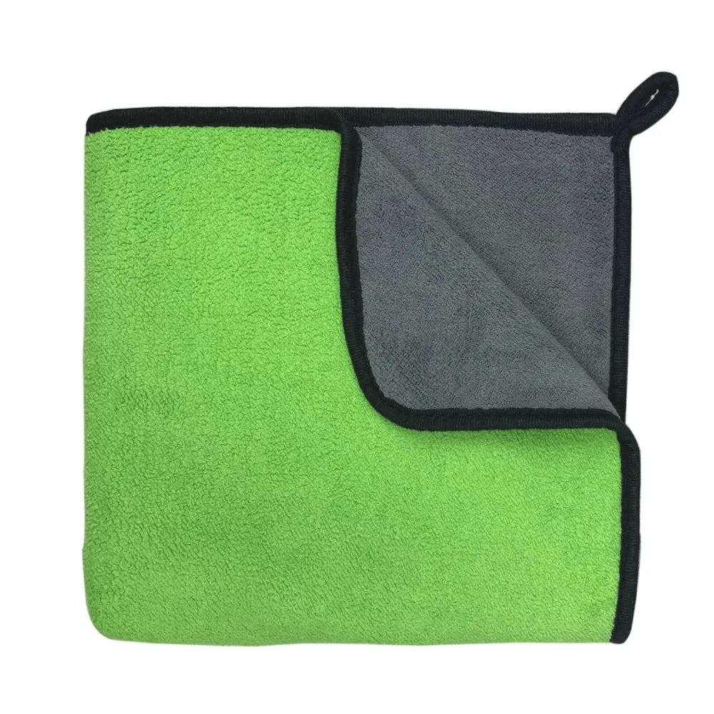 The towel being used as a blanket for a pet on a couch.