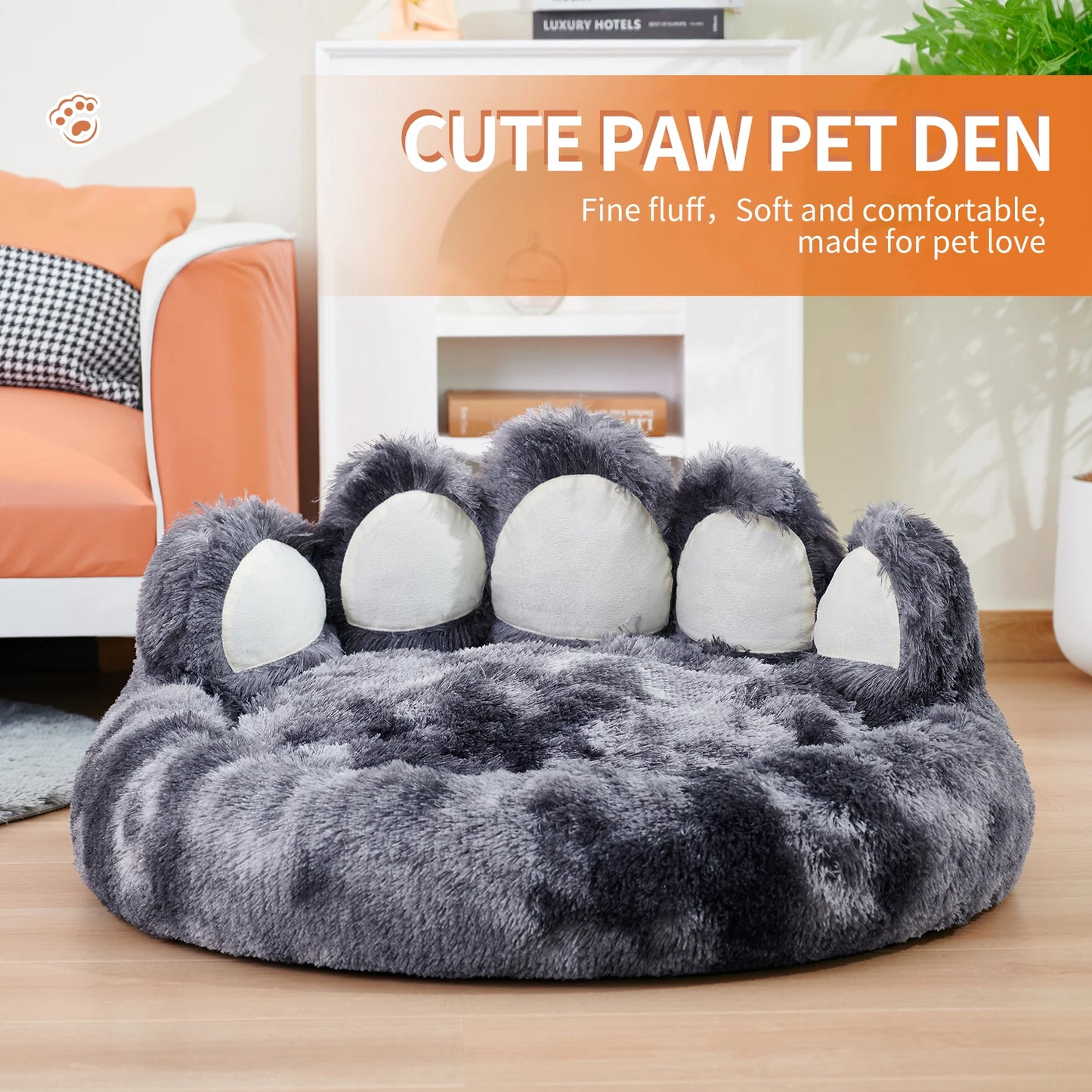 Gray paw-shaped pet bed on a wooden floor with a modern living room background.