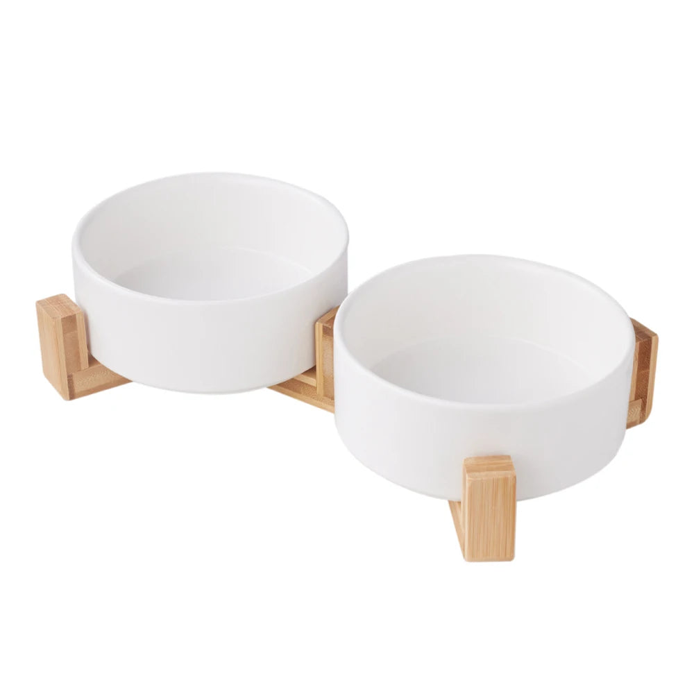 Two white bowls on a wooden stand against a white background