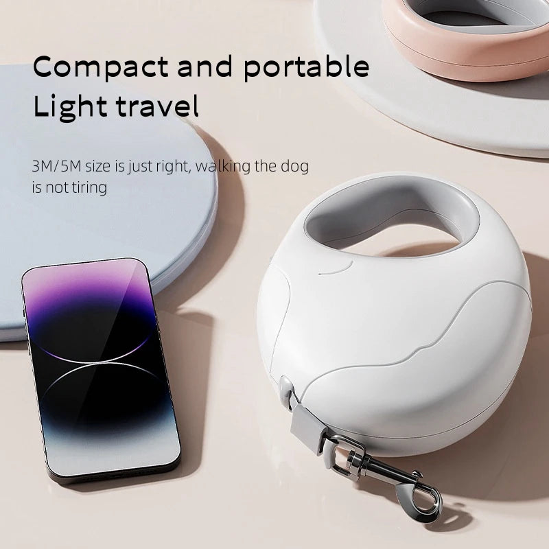 Compact and portable dog leash with smartphone for scale on a light background