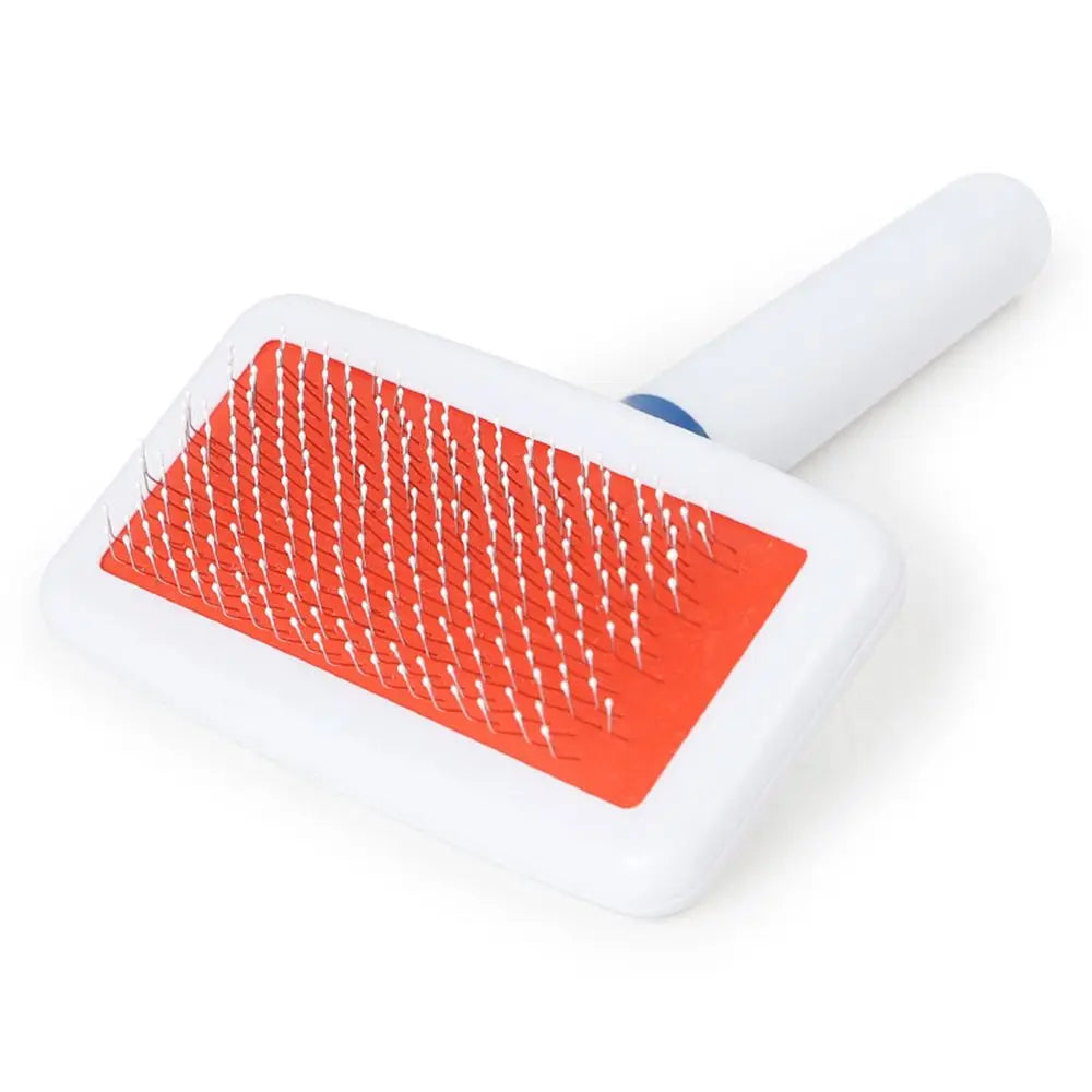 Pet grooming brush with red rubber plate on a white background
