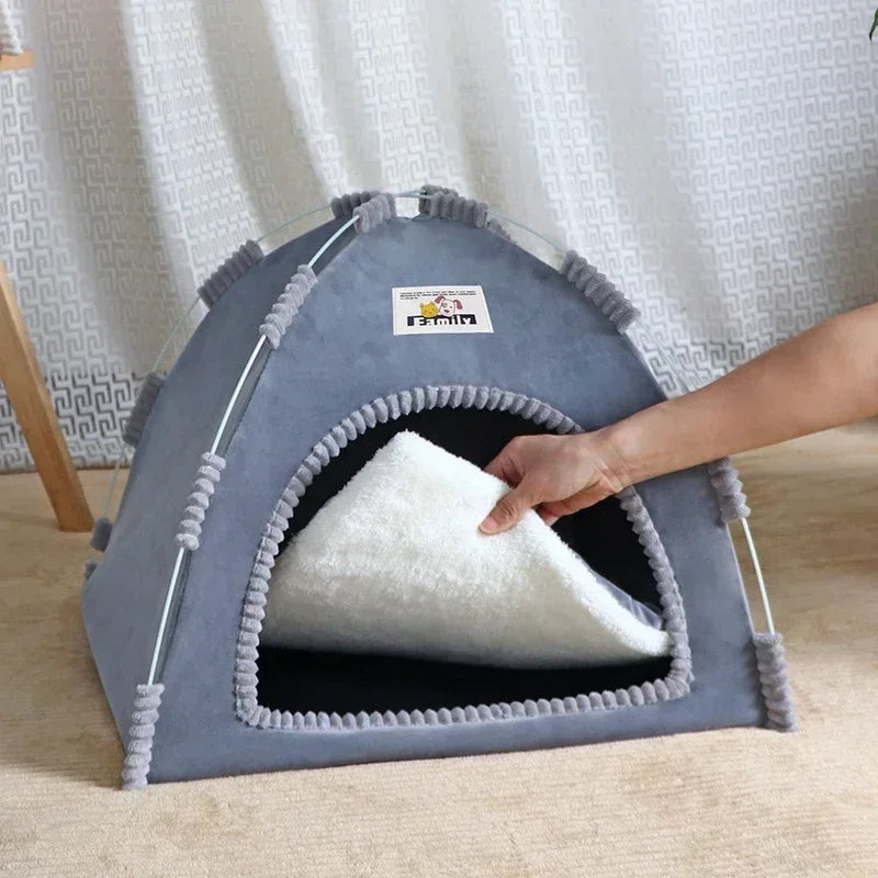 Gray pet tent with a hand reaching inside, set against a light curtain background.