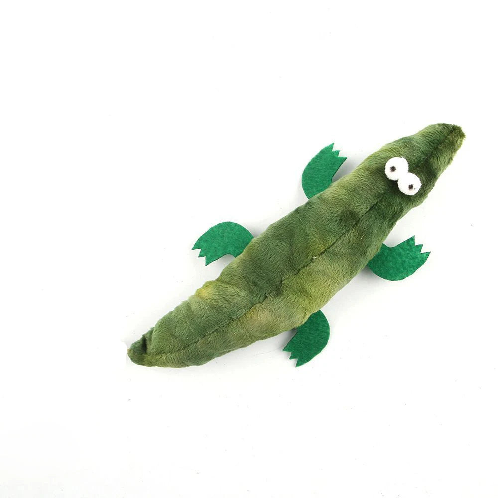Green plush toy resembling a pickle with googly eyes on a white background
