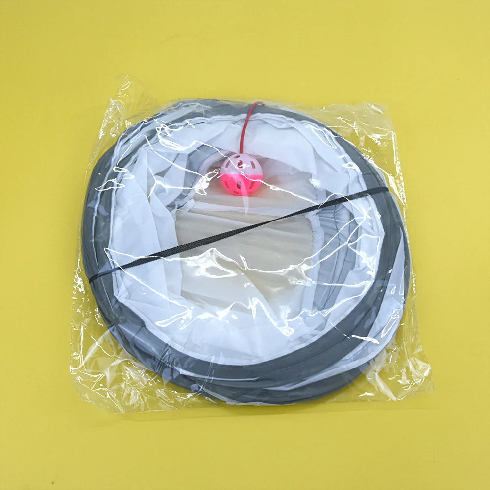 Fishing reel with line and pink bobber in clear plastic packaging on a yellow background