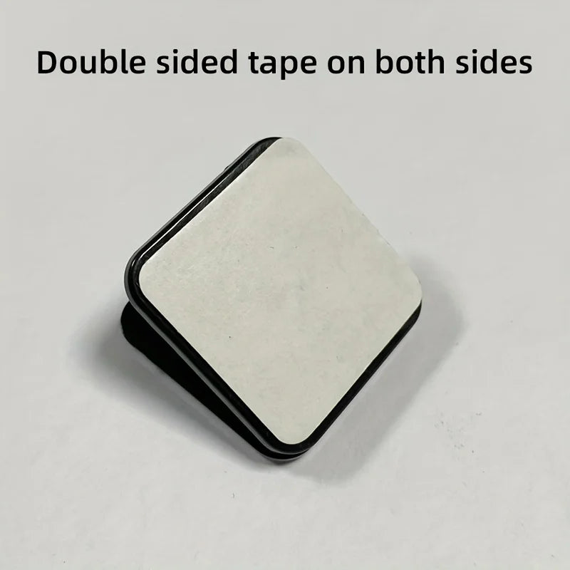 Pee pad clip securely holding a pad against the wall in a modern home setting.
