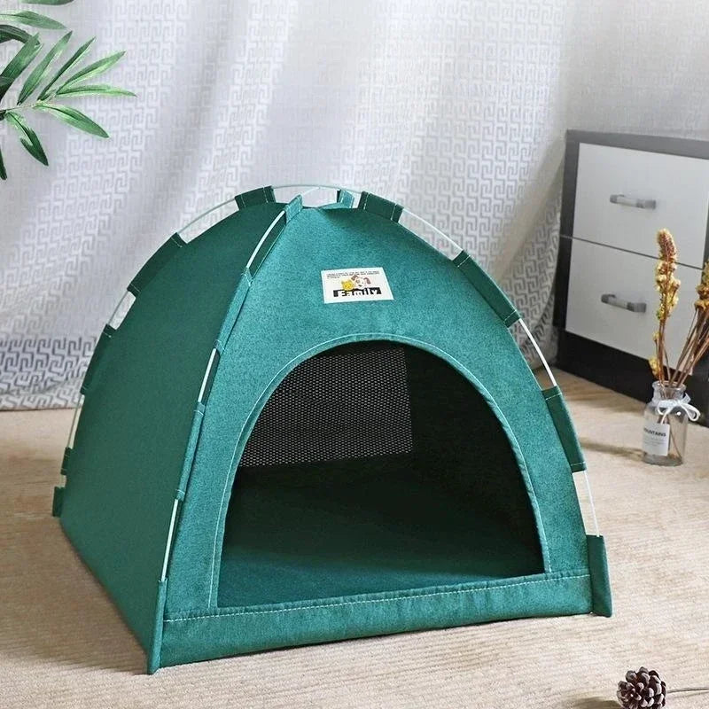 Green pet tent with a visible brand logo on a light wooden floor.