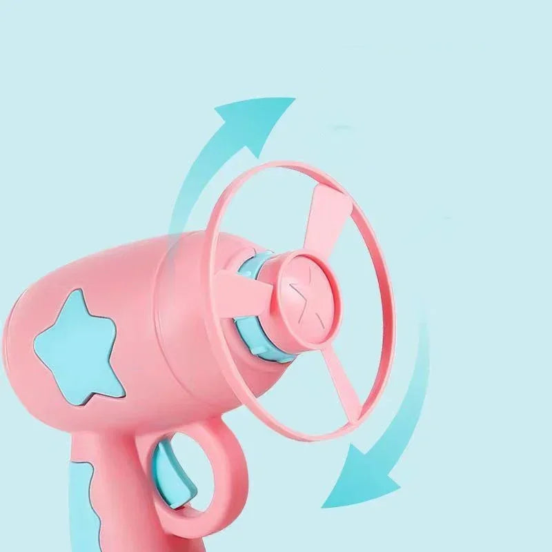 Pink toy hair dryer with blue accents on a light blue background