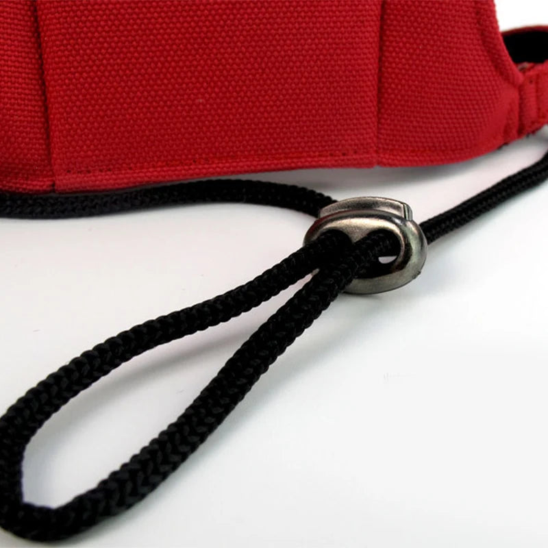 Close-up of a red cap with a black chin strap on a white background