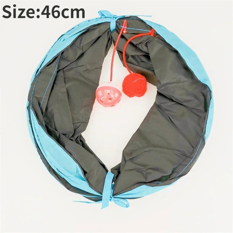 Round pet bed with gray interior and blue exterior, featuring a red toy inside.