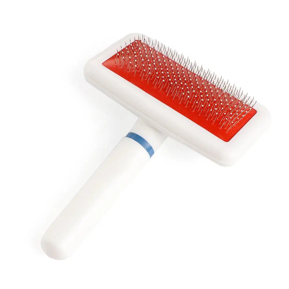 Pet grooming brush with red surface and white handle on a white background