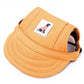 Orange pet visor with a small label featuring a dog design on a white background