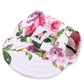 Floral-patterned pet hat with a brand label on a white background