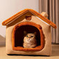 Cat inside a cozy pet house with a teddy bear on top