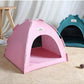 Pink pet tent on a wooden floor with a white curtain background