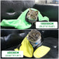 A medium-sized towel drying a cat after a bath.
