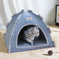 Cat inside a gray pet tent on a light-colored floor.