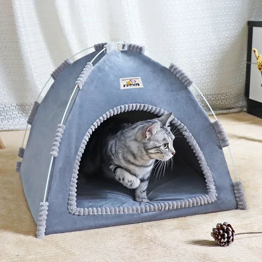 Cat inside a gray pet tent on a light-colored floor.