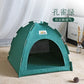 Green pet tent on a wooden floor with a white curtain in the background