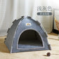 Gray pet tent on a wooden floor with a white curtain in the background