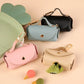 Stylish faux leather poop bag holder in classic black with attached clip.