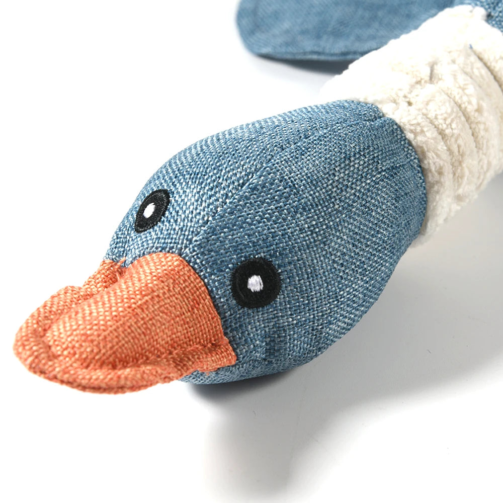 Blue duck-shaped toy with an orange beak on a white background