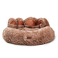 Brown fluffy pet bed with paw-shaped handles on a white background