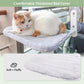 Cat lounging on a soft, thickened bed cover attached to a chair.