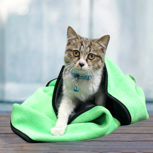 Small microfiber pet towel draped over a wet puppy for drying.