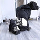 Rottweiler wearing a Reflective Winter Dog Hoodie during a walk.